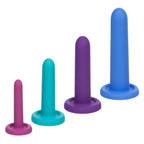 Four silicone sleeve training devices in ascending size order, featuring pink, teal, purple, and blue colors, displayed on a solid white background.